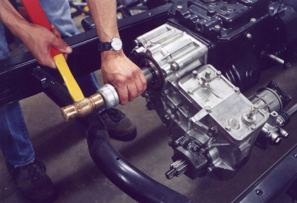 Driving the bearing onto the output shaft and into the rear of the transfer case.